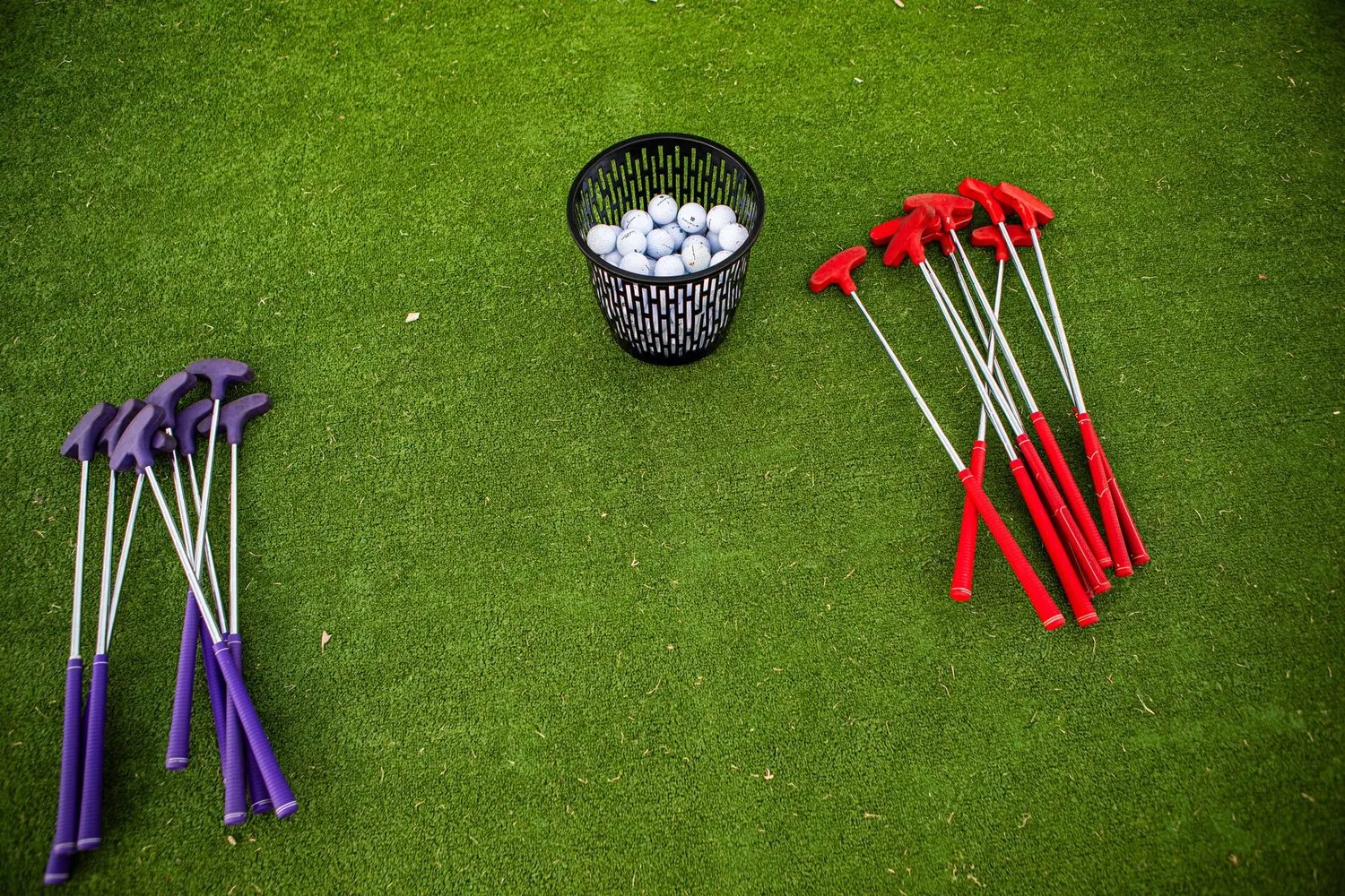Lucky Shot mini golf putters and balls on green turf